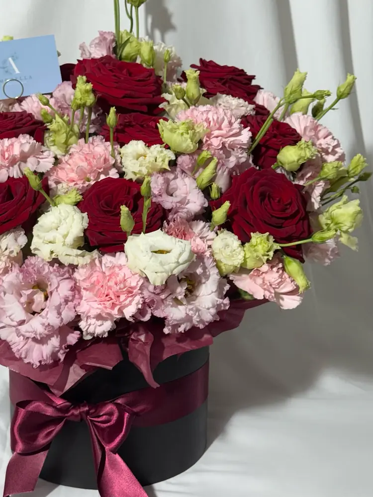 Red rose, pink carnation and lisianthus hatbox arrangement