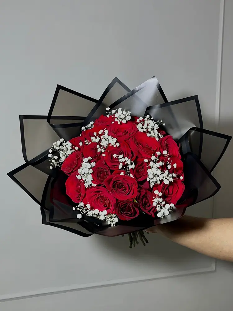 Red roses and gypsophila in black Korean style wrap