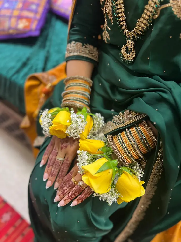 Yellow rose and gypsophila gajras for a bride