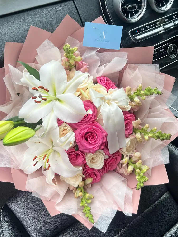 Rose and lily bouquet in pink wrap