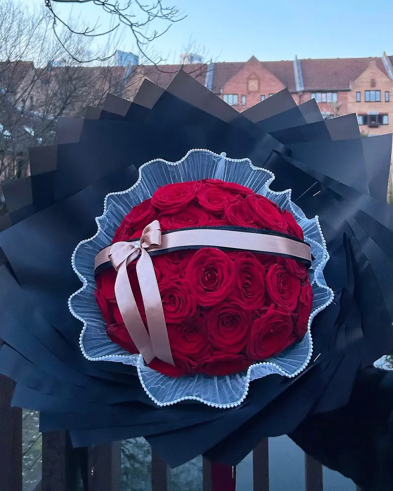 Large red rose bouquet with a satin bow