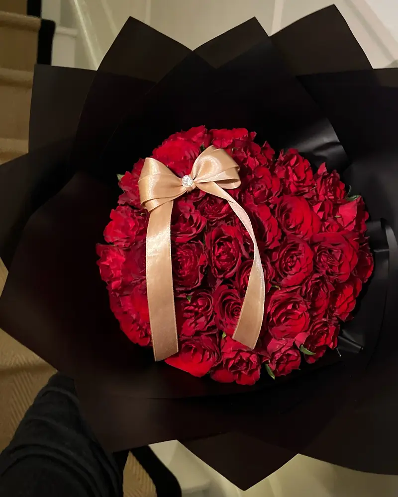 Red rose bouquet with a gold satin bow