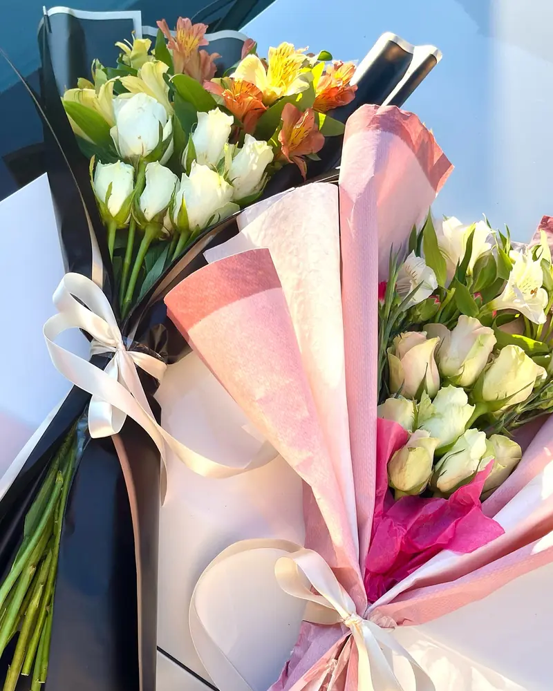 Pastel spring bouquets in pink wrap